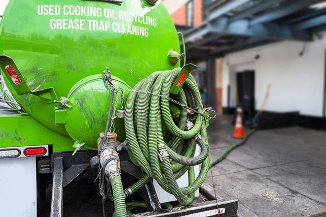 a professional technician pumping a restaurant's grease trap in Bay Shore NY